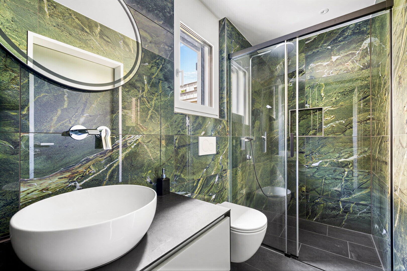 bathroom with vanity, tile walls, and a marble finish shower