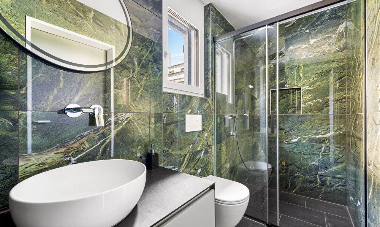 bathroom with vanity, tile walls, and a marble finish shower