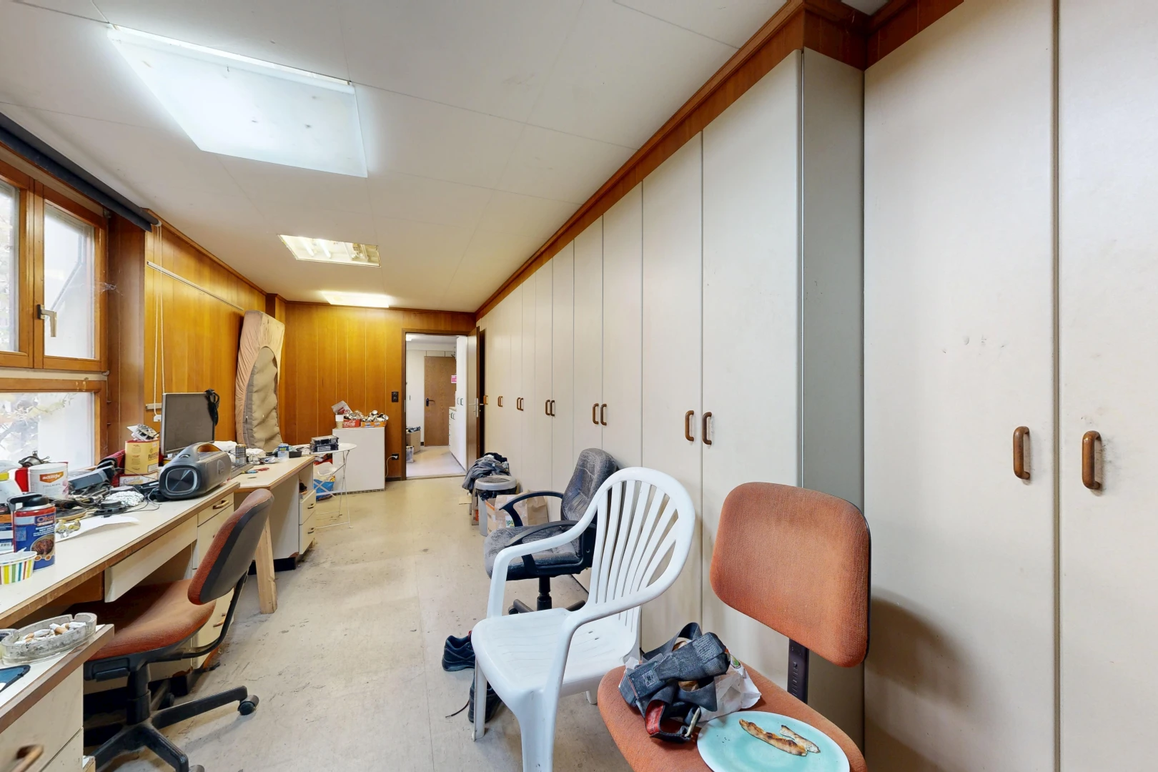 office featuring built in study area and wood walls