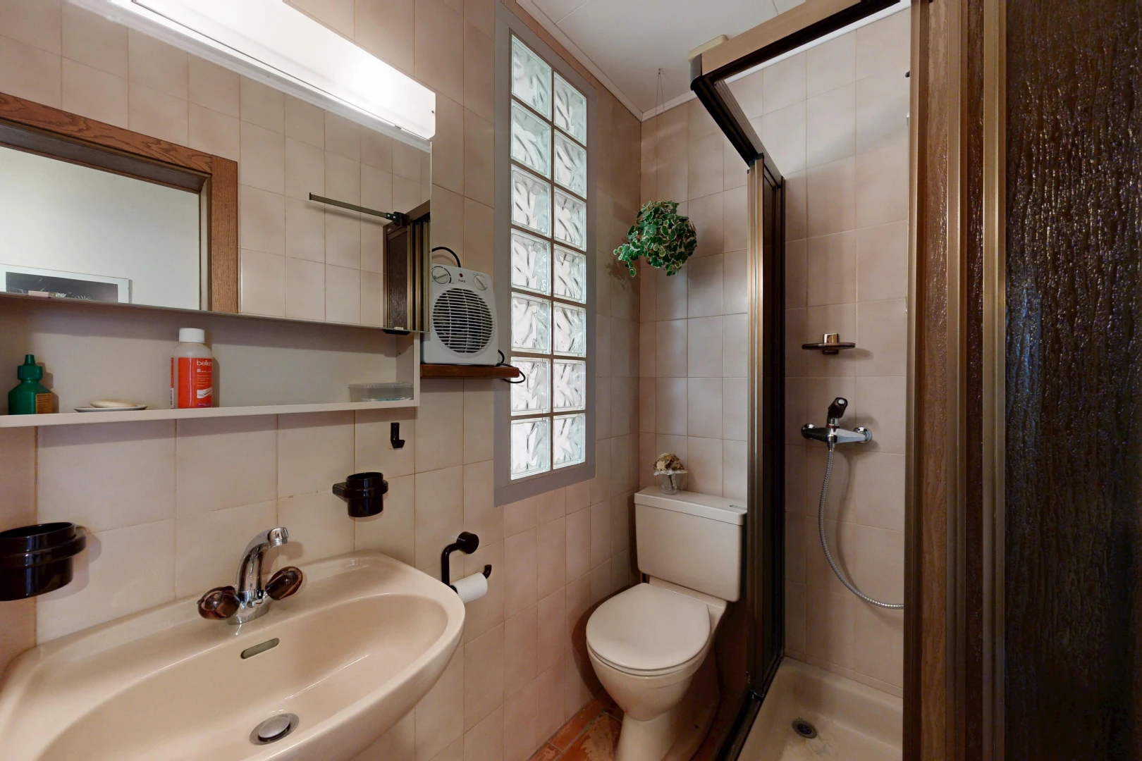 bathroom featuring a shower stall and tile walls