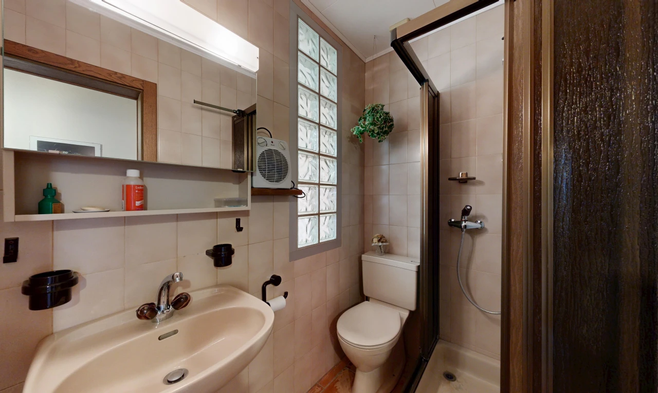 bathroom featuring a shower stall and tile walls