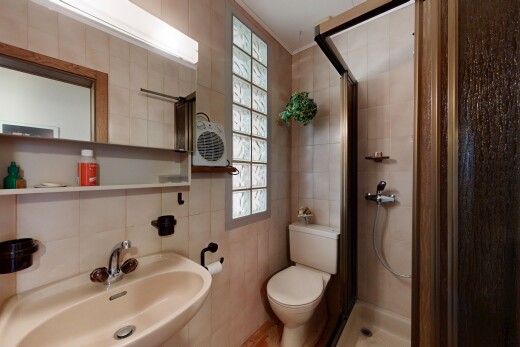 bathroom featuring a shower stall and tile walls
