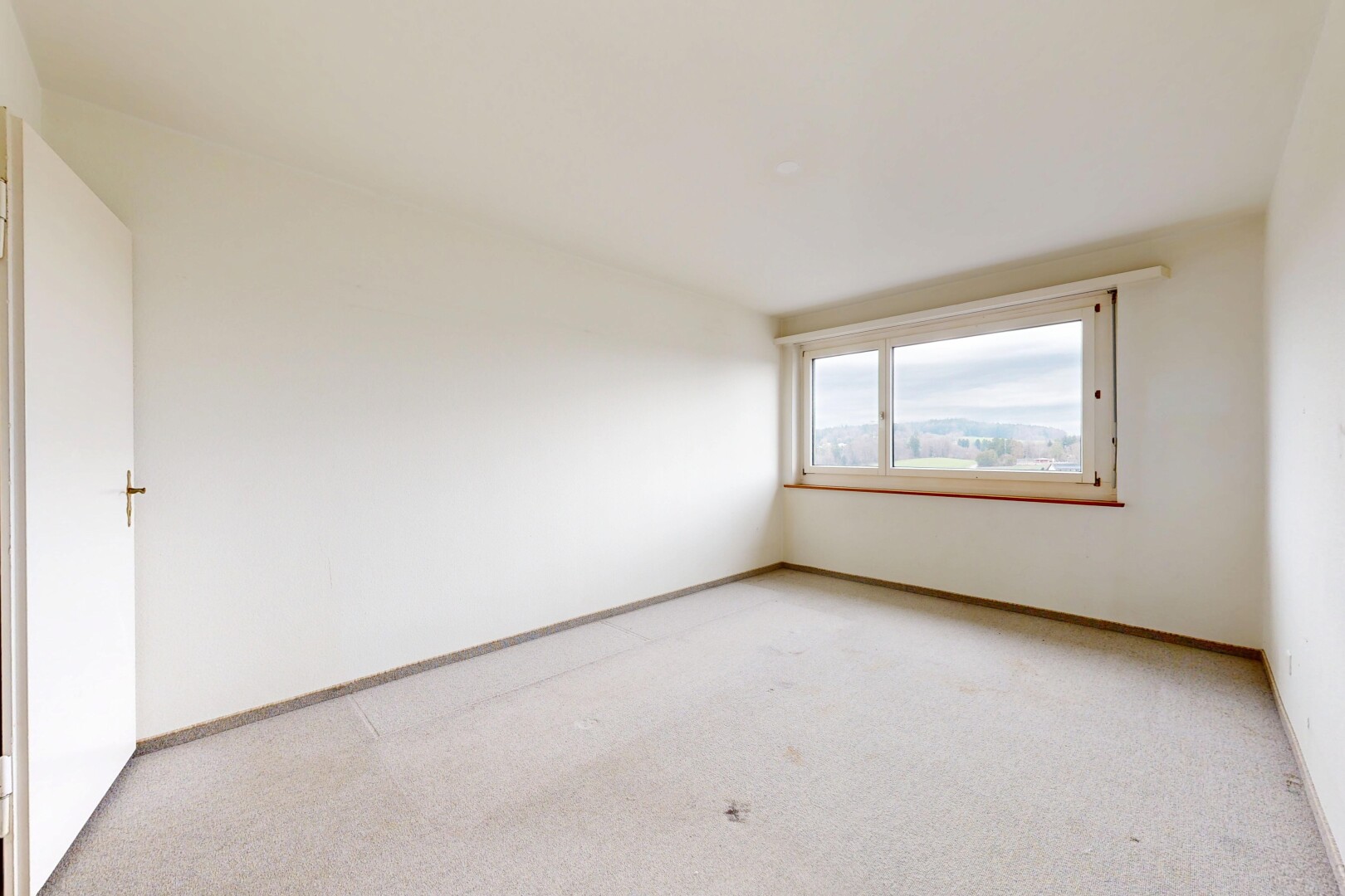 empty room with light carpet and baseboards