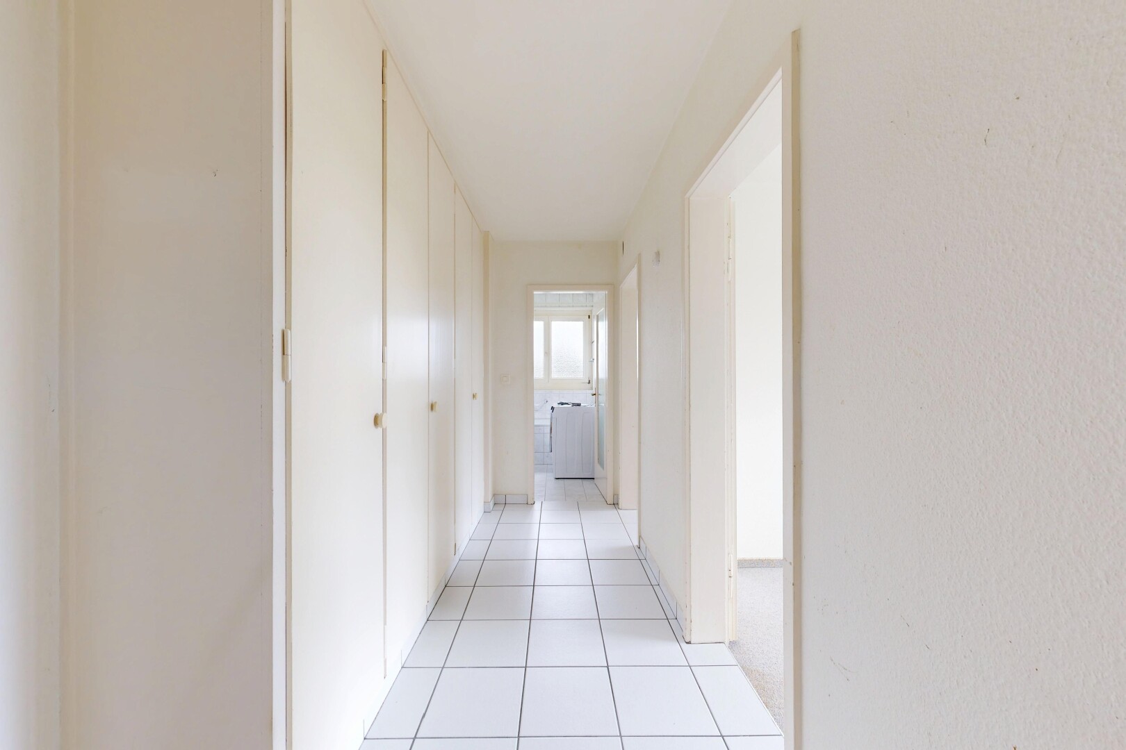 hallway with light tile patterned floors