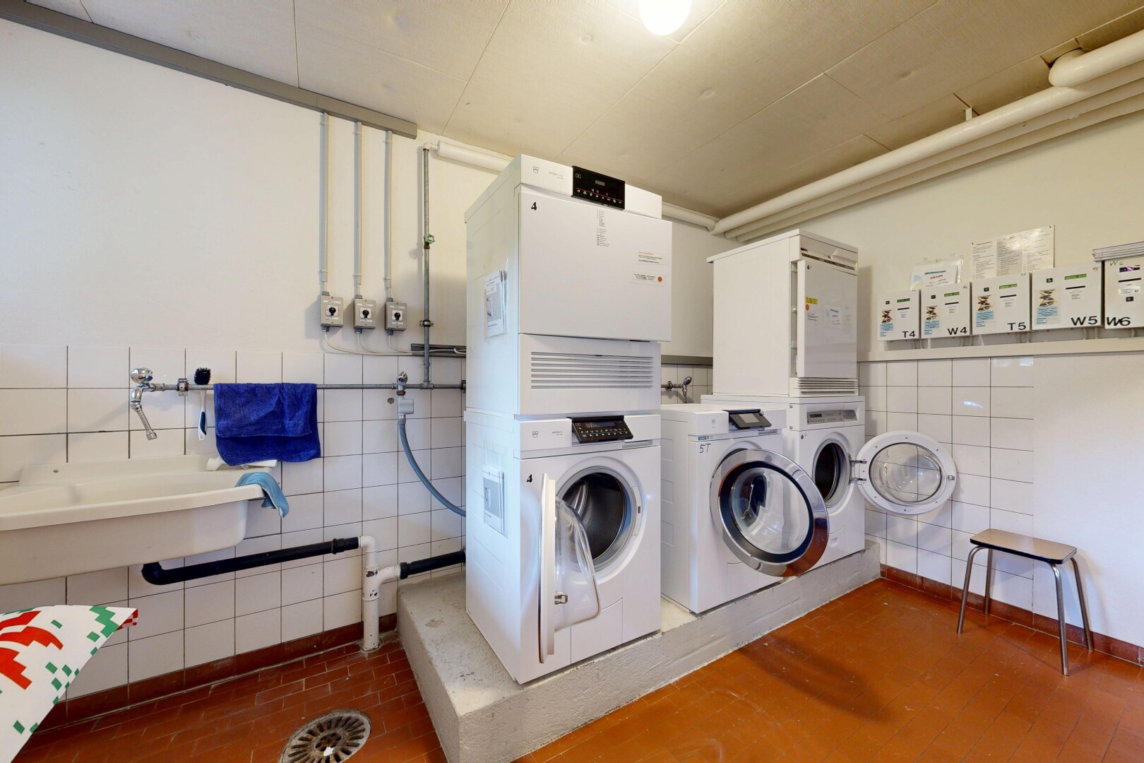 community laundry room with tile walls and separate washer and dryer