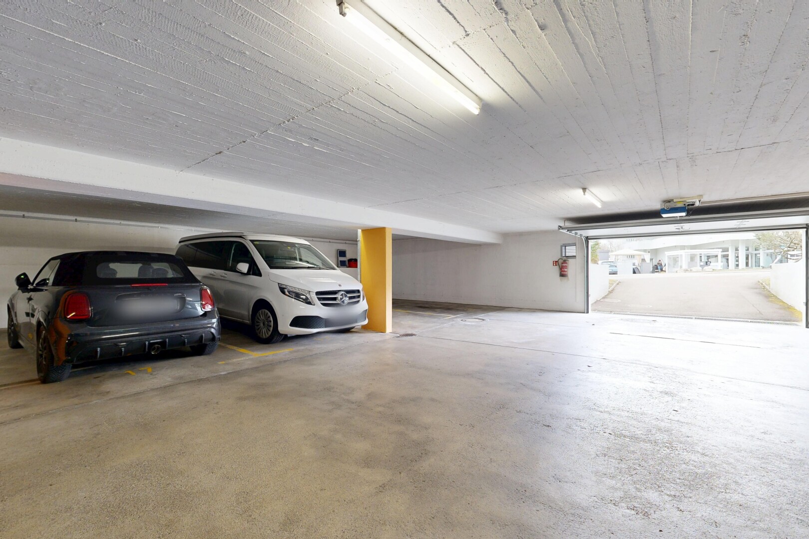 view of parking with a parking garage