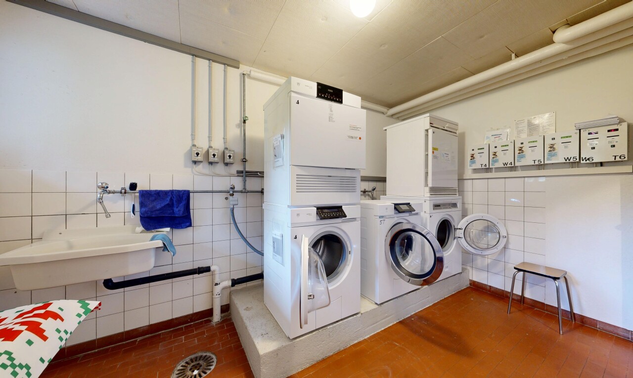 community laundry room with tile walls and separate washer and dryer