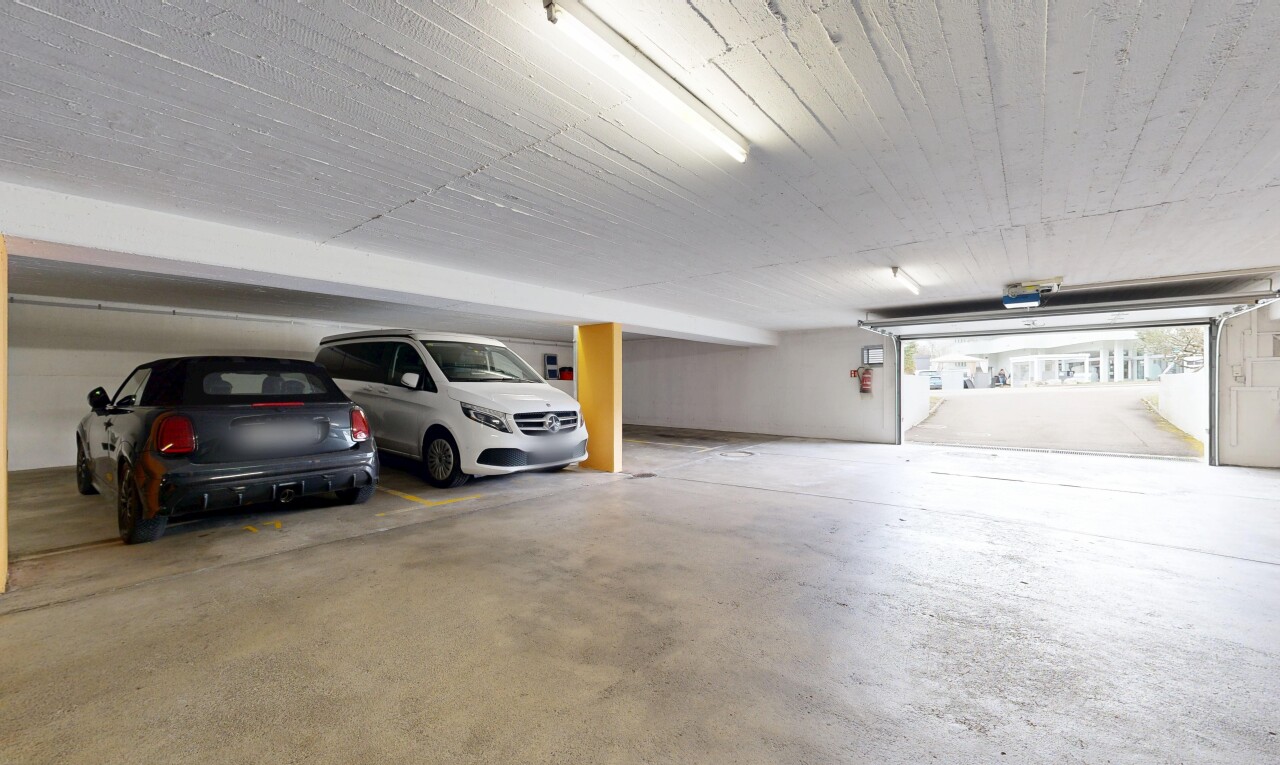 view of parking with a parking garage