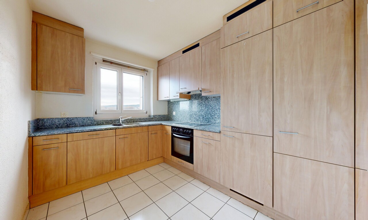 kitchen featuring light wood finish cabinets, black appliances, tasteful backsplash, and light tile patterned floors