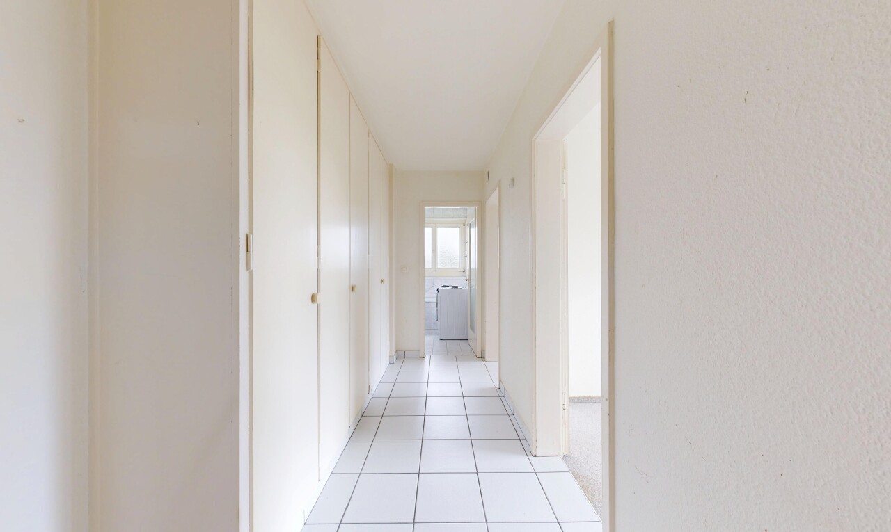 hallway with light tile patterned floors