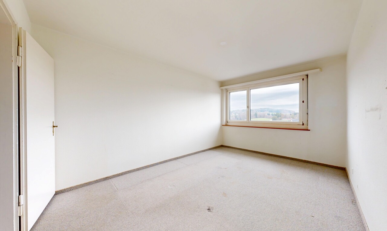 empty room with light carpet and baseboards