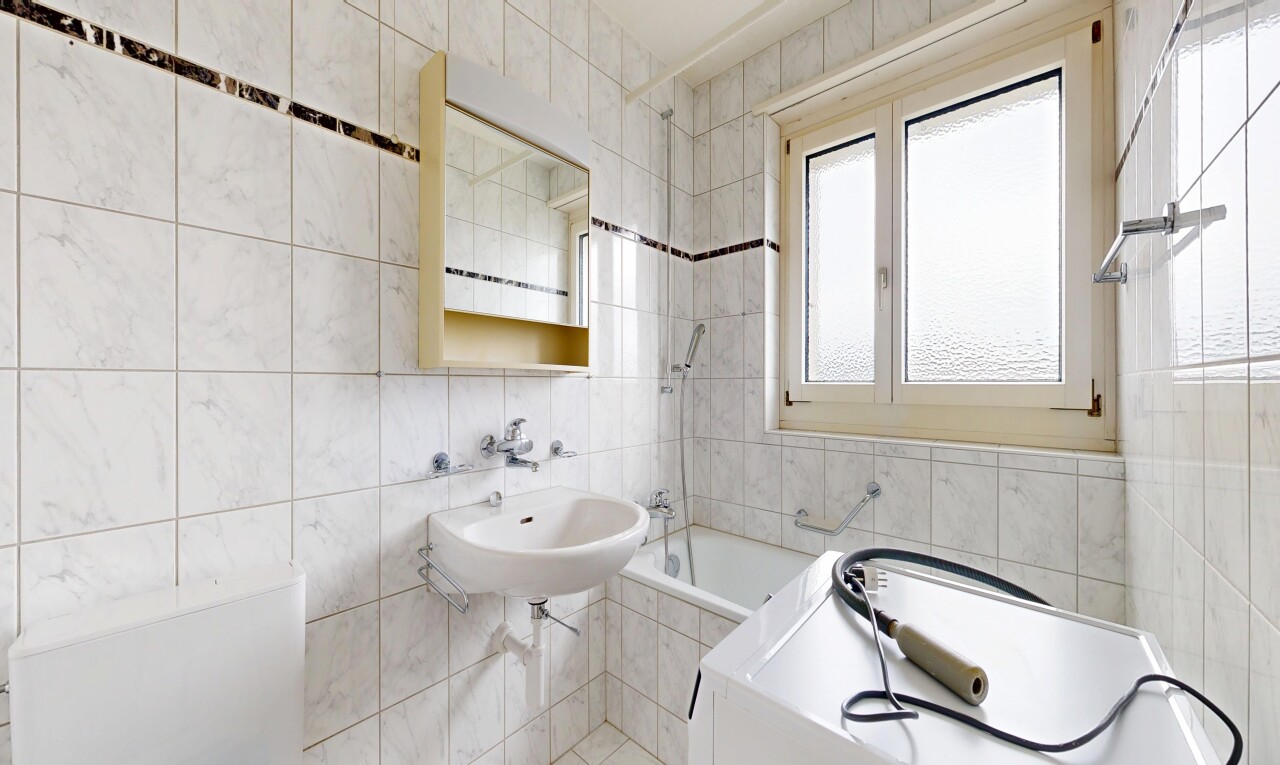 full bath with a garden tub and tile walls