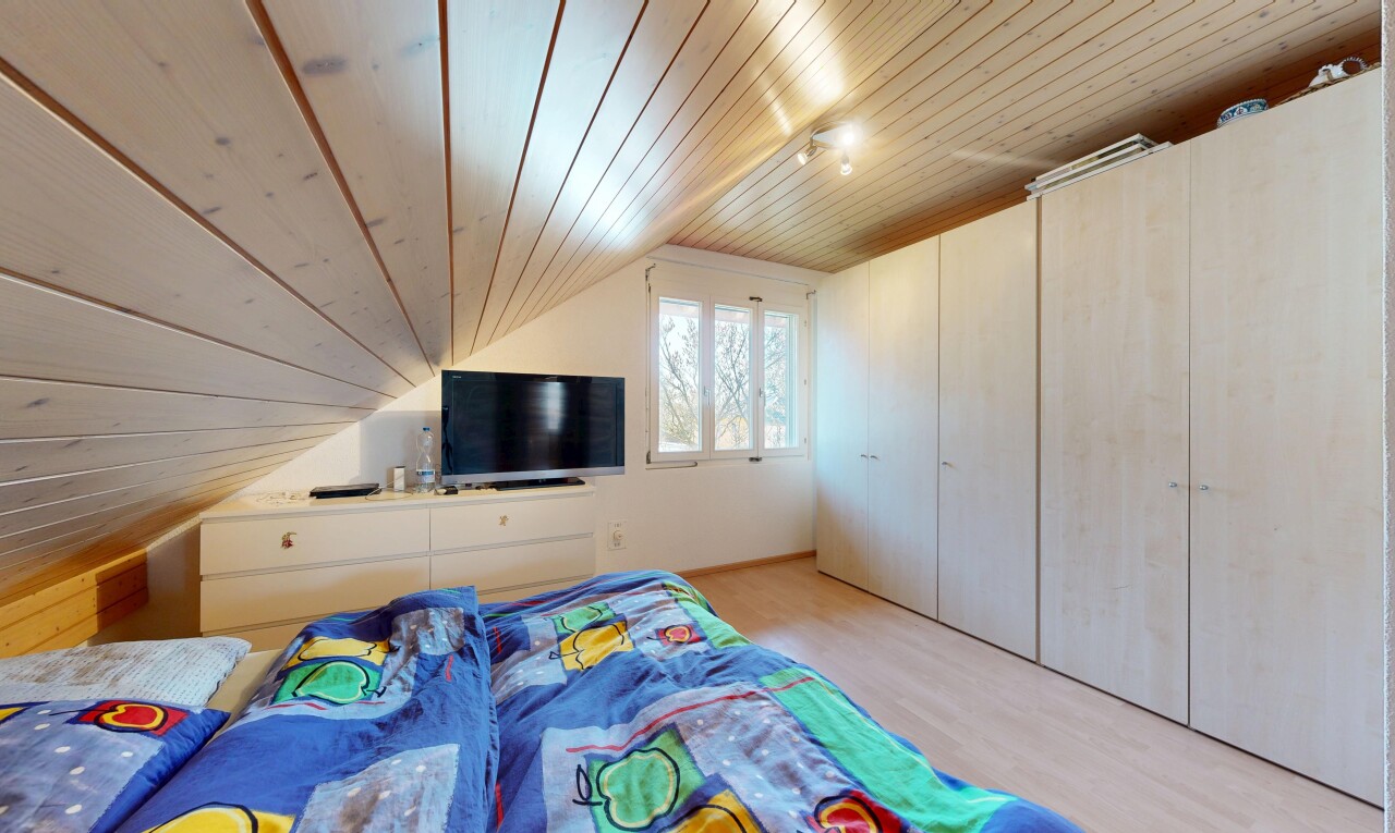 chambre avec pièce supplémentaire, plafond en bois, wood ceiling, télévision, et sol en finition bois