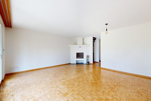 spare room featuring parquet flooring and a fireplace