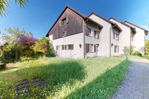 view of property with stucco siding and a lawn