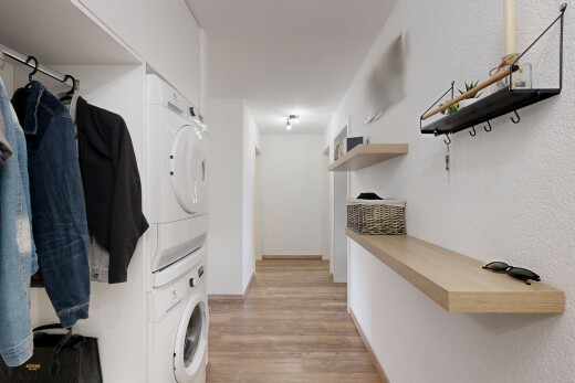 wäschekammer mit wäscherei, waschturm, inside property, light floor, und holzfußboden