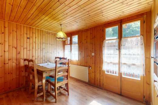 dining area with wood ceiling, wood walls, light hardwood / wood-style flooring, and radiator