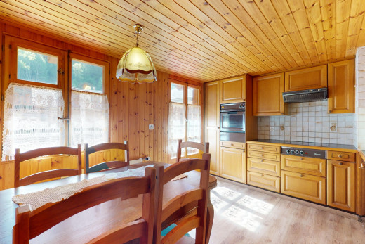 kitchen with hanging light fixtures, plenty of natural light, light wood-type flooring, and wood ceiling