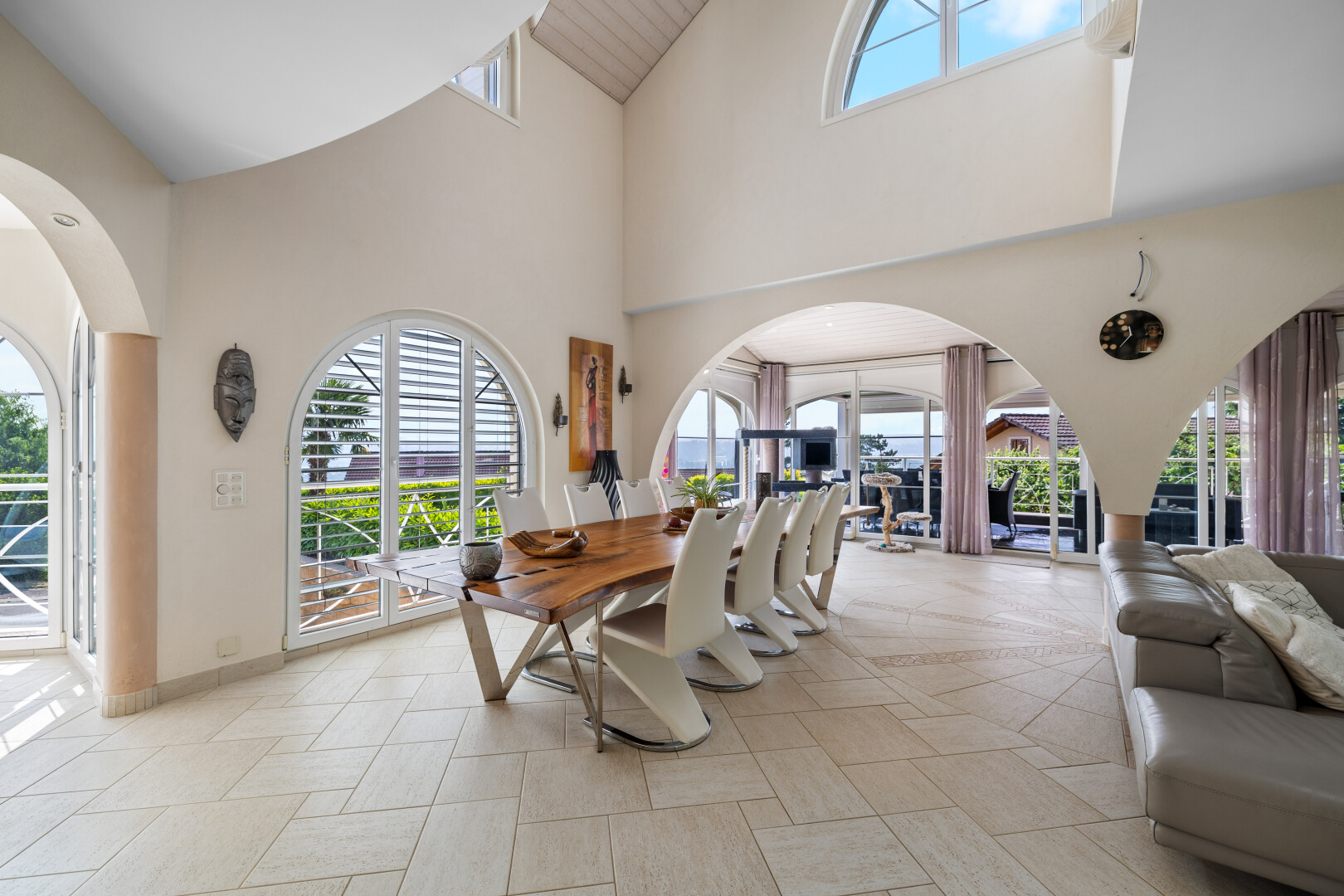 dining space with high vaulted ceiling and baseboards