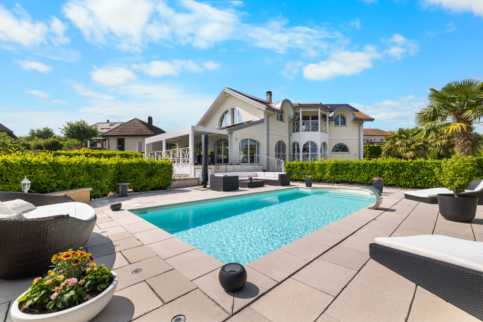 outdoor pool with outdoor lounge area and a patio