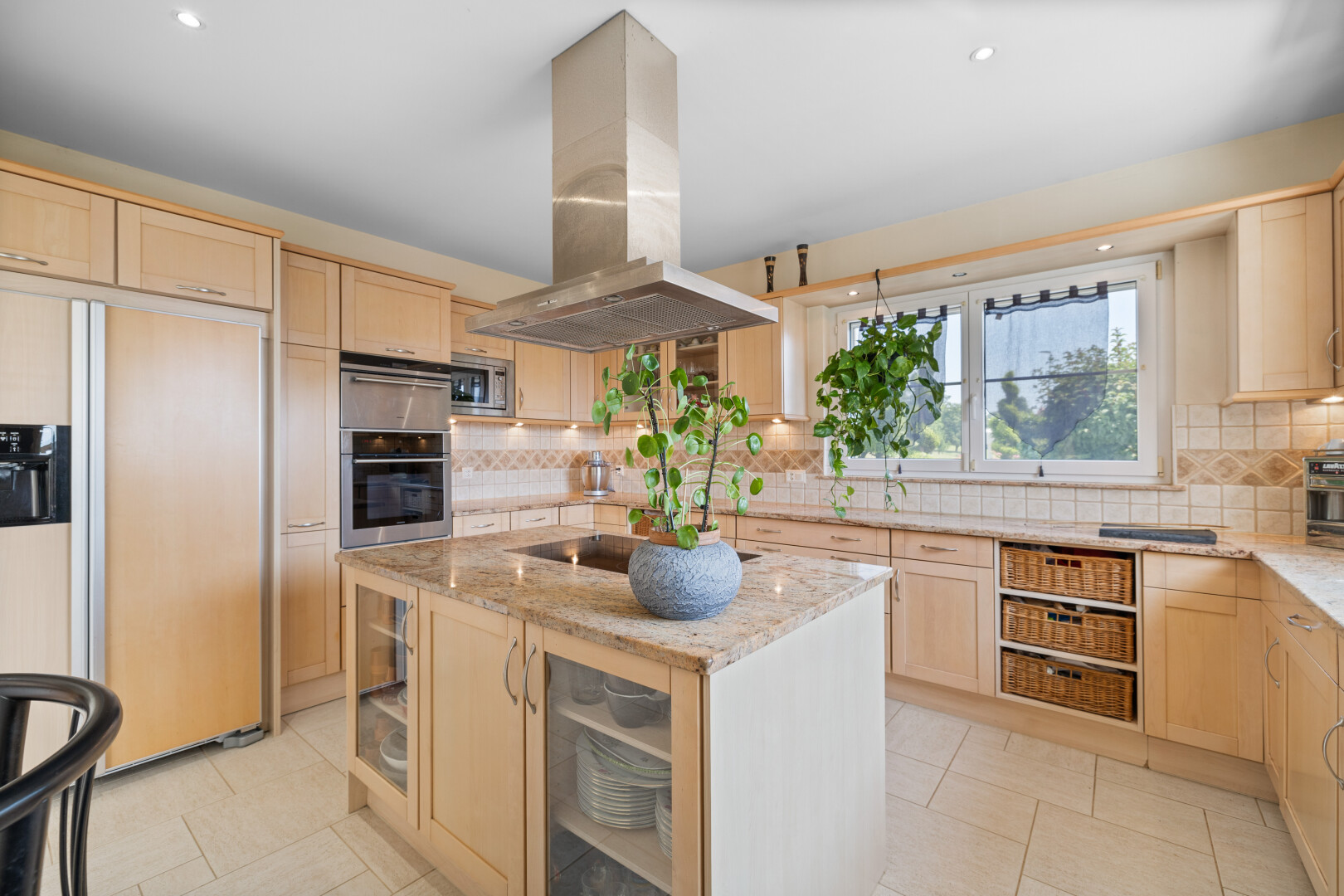 kitchen with stainless steel appliances, island exhaust hood, light brown cabinets, and recessed lighting