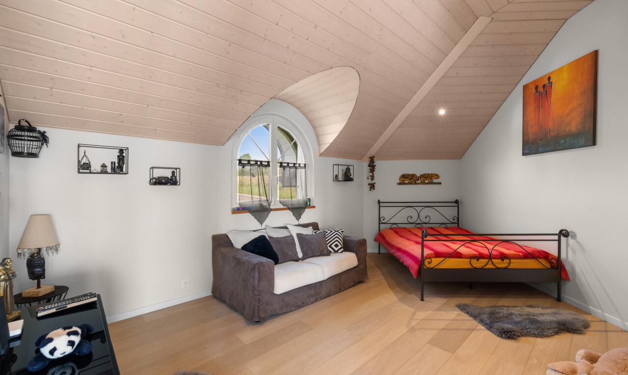 room / bedroom featuring vaulted ceiling, wood finished floors, and wooden ceiling