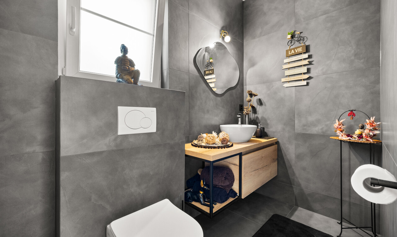 half bathroom with vanity and toilet