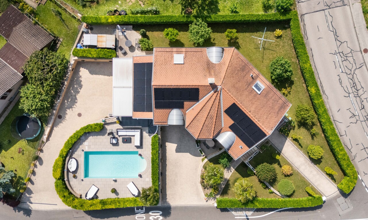 view of property with roof mounted solar panels and stucco siding