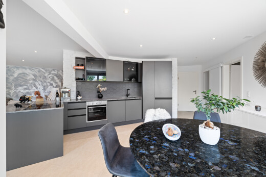 kitchen featuring gray cabinets, tasteful backsplash, open shelves, stainless steel oven, and modern cabinets