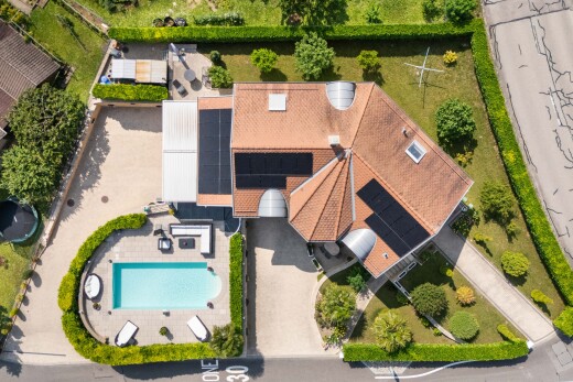 view of property with roof mounted solar panels and stucco siding