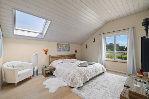 room featuring a skylight, lofted ceiling, and wood finished floors