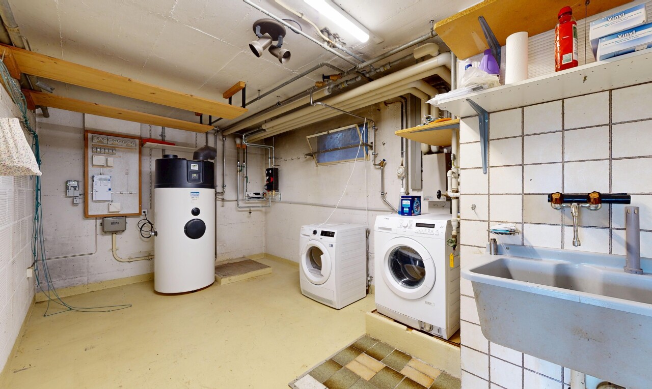 wäschekammer mit inside property, tumbler, waschbecken, betonboden, und concrete floor