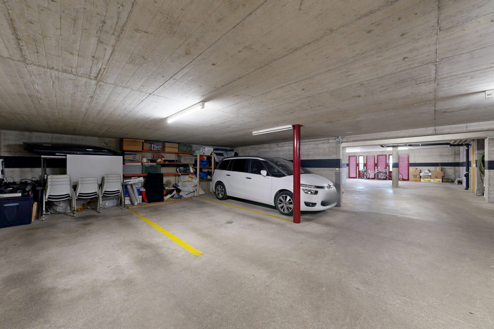 view of parking with a parking garage