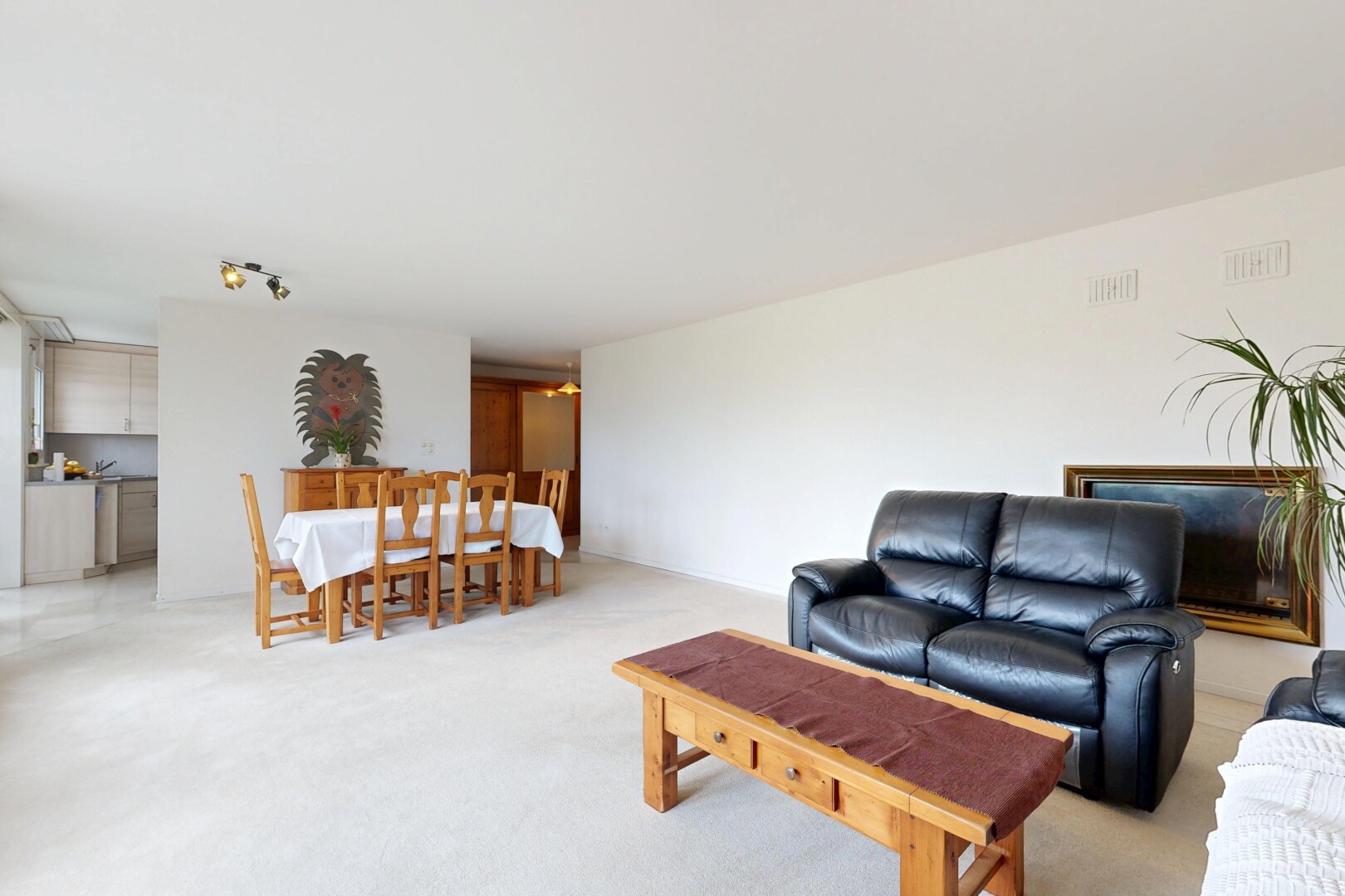 living / dining room featuring light colored carpet