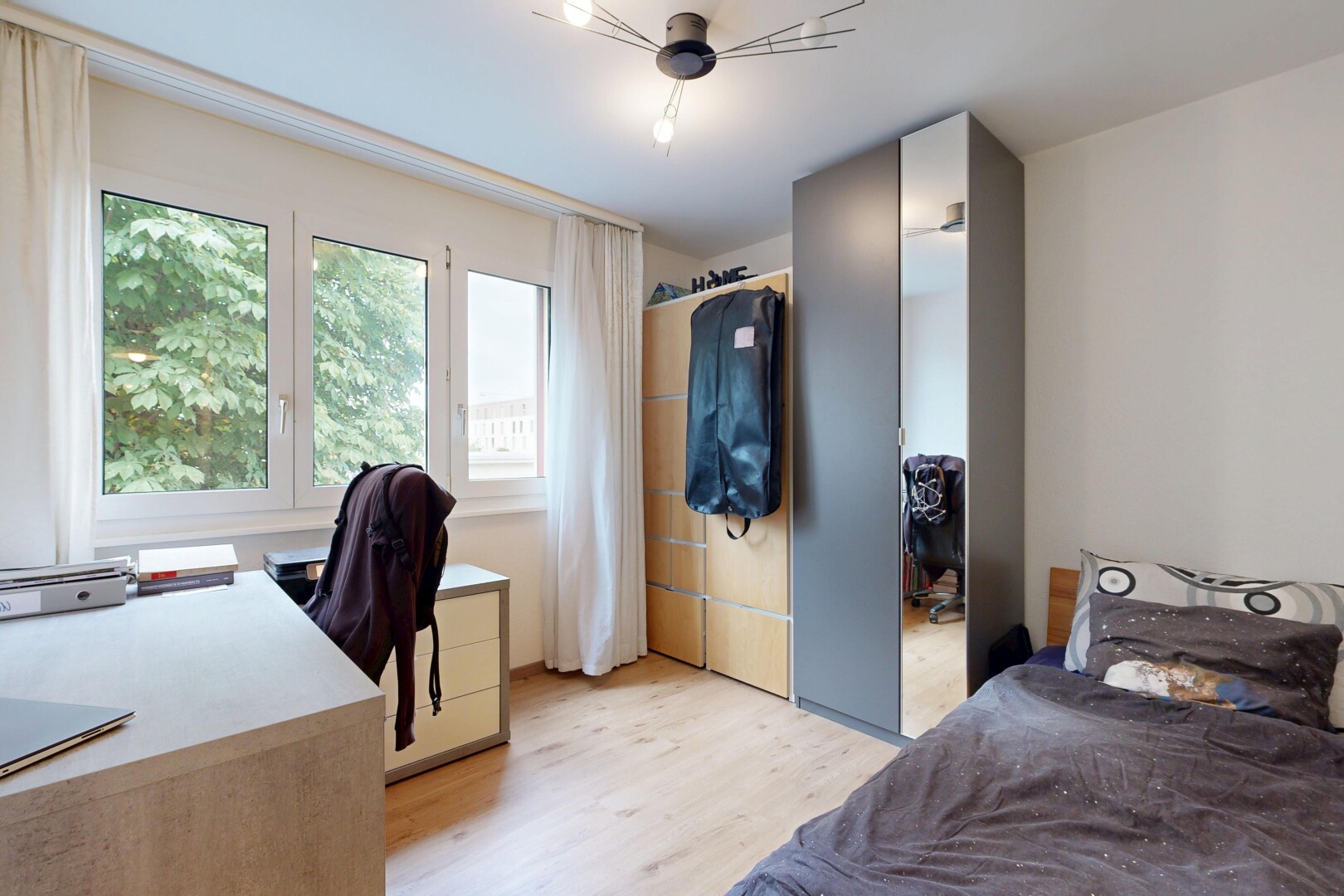 room / bedroom with a desk and light wood-type flooring