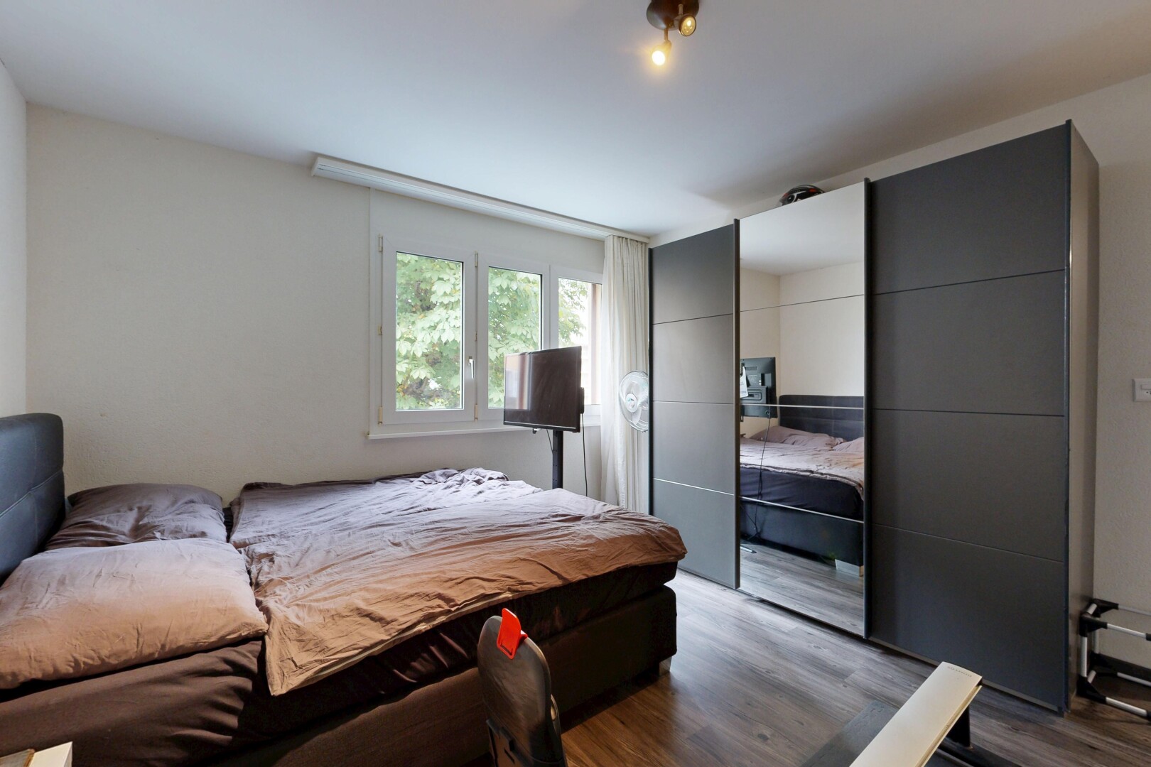 room featuring dark wood-type flooring and a closet