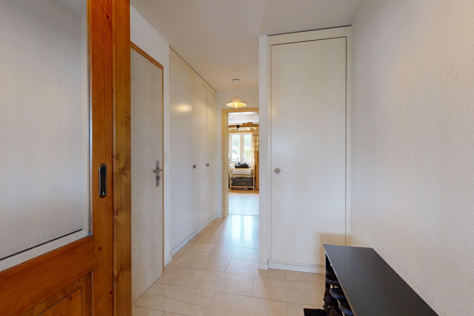corridor with light tile patterned floors