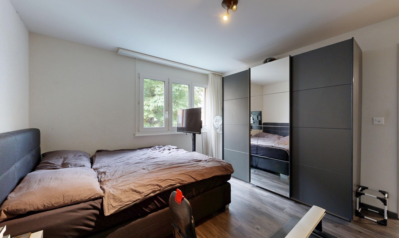 room featuring dark wood-type flooring and a closet