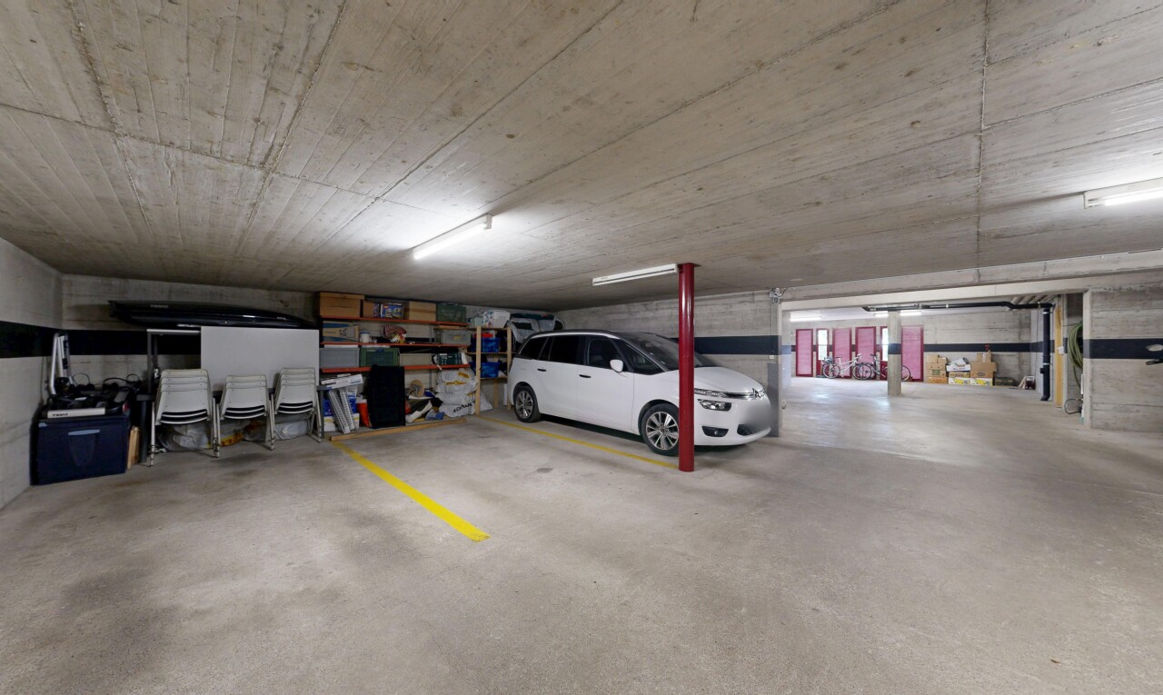 view of parking with a parking garage