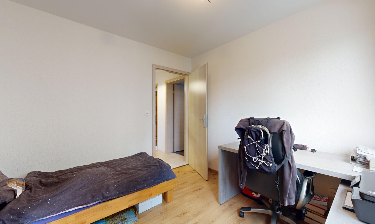 room / bedroom featuring an office area and light wood-style flooring