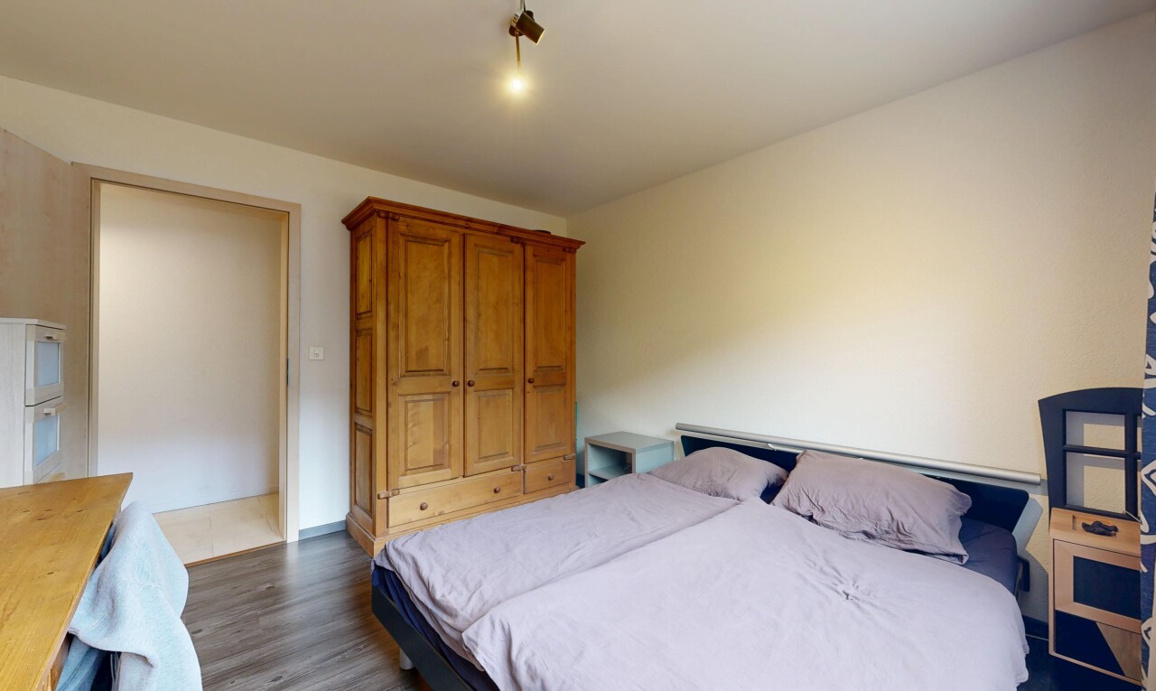 room / bedroom with dark wood finished floors