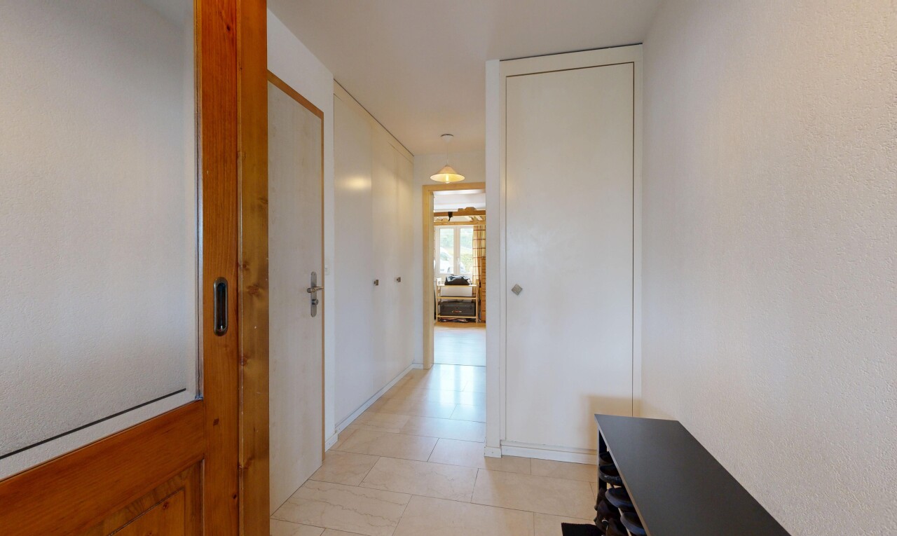 corridor with light tile patterned floors