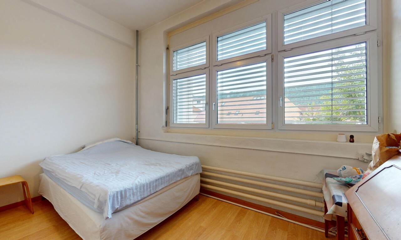 chambre avec natural light, lumière naturelle, wood finish floor, sol en finition bois, et drywall