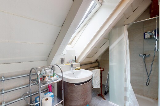 salle de bains avec puits de lumière, salle de bain complète, lavabo (ou coiffeuse selon le contexte), douche, et inside property