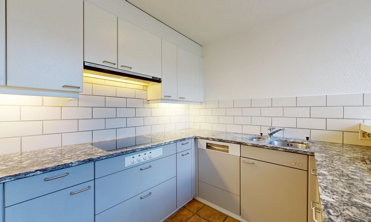 kitchen featuring stone countertops, light tile patterned flooring, and backsplash