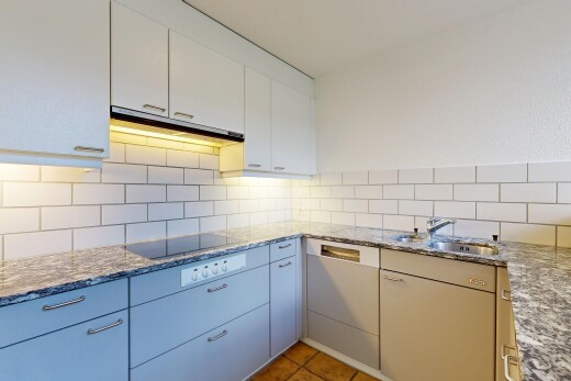 kitchen featuring stone countertops, light tile patterned flooring, and backsplash
