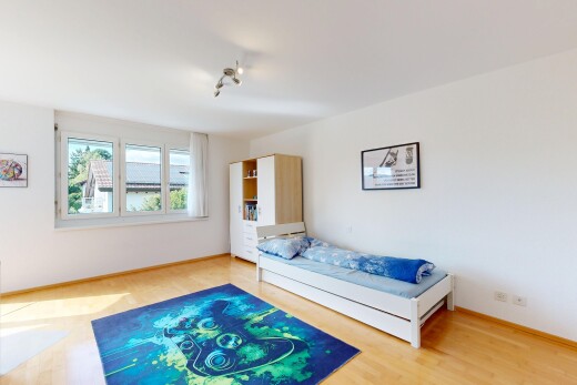 room / bedroom featuring light wood-style flooring and baseboards