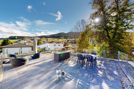 terrace featuring outdoor dining area, a mountain view, and a residential view