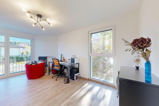 office with light wood-style floors and a chandelier