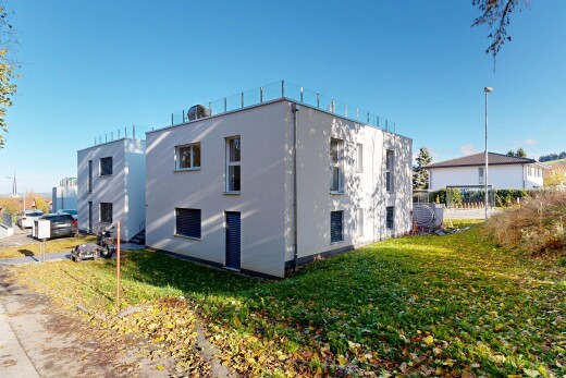 view of home with stucco siding and a yard